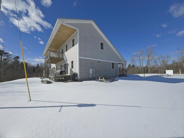 view of snow covered exterior featuring a balcony