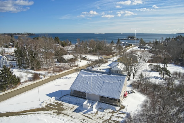 snowy aerial view featuring a water view