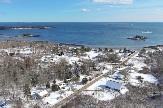 snowy aerial view featuring a water view
