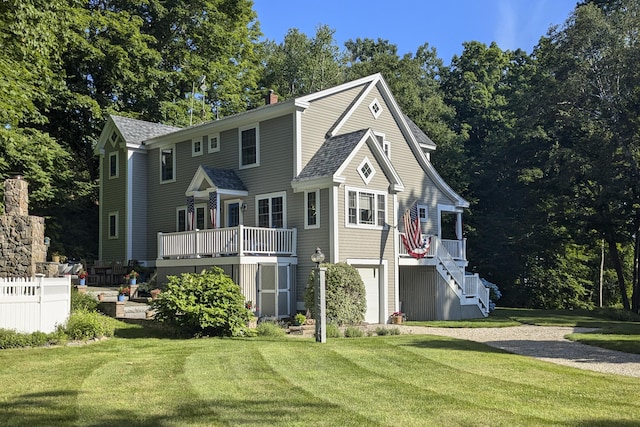 back of property featuring a garage and a lawn