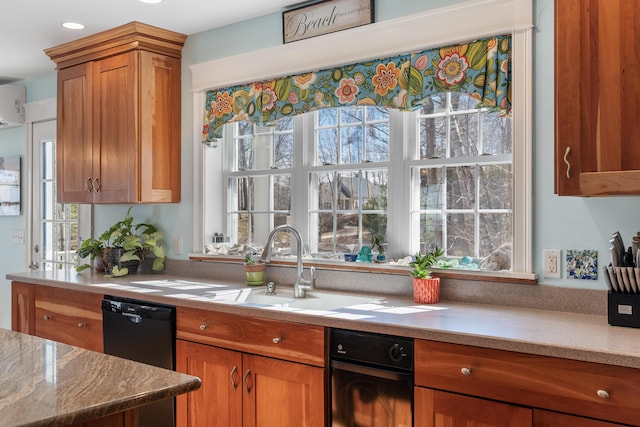 kitchen featuring plenty of natural light, black dishwasher, and sink