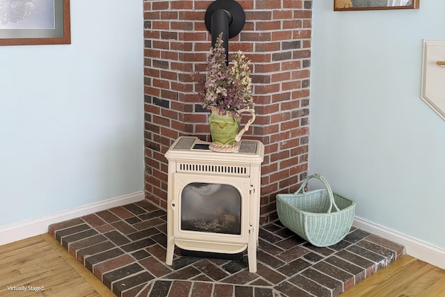 details with hardwood / wood-style floors and a wood stove