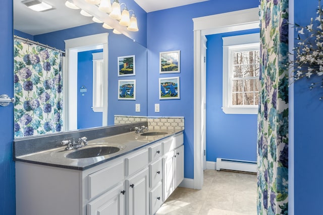 bathroom with a baseboard radiator, tile patterned floors, and vanity