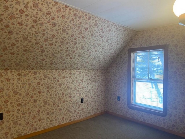 bonus room featuring lofted ceiling and carpet floors