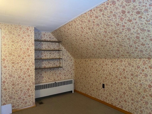 bonus room featuring radiator heating unit, carpet flooring, and vaulted ceiling