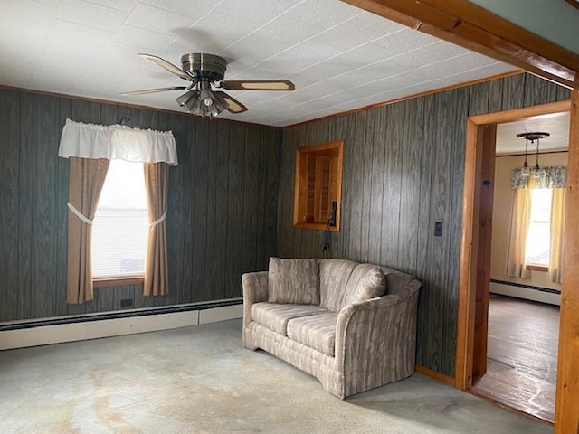 unfurnished living room featuring ceiling fan, a baseboard radiator, and carpet floors