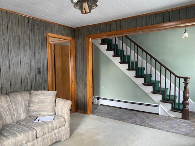 living room featuring a baseboard heating unit and wooden walls