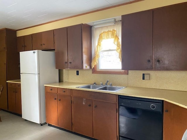 kitchen with white refrigerator, black dishwasher, sink, and decorative backsplash