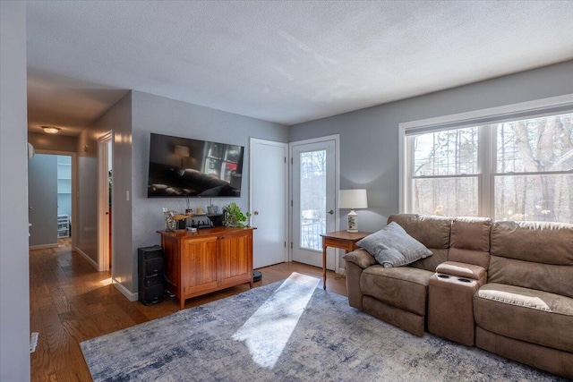 living room featuring dark hardwood / wood-style floors and a textured ceiling