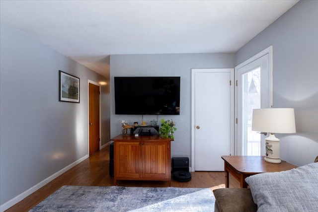 bedroom with dark hardwood / wood-style flooring