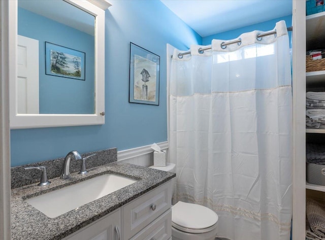 bathroom with vanity, toilet, and walk in shower