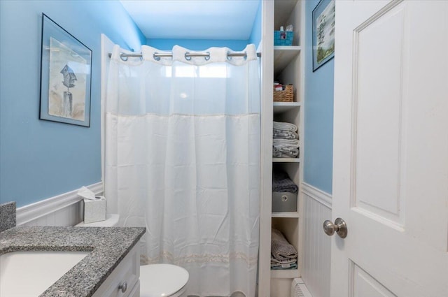 bathroom featuring baseboard heating, vanity, toilet, and a shower with curtain