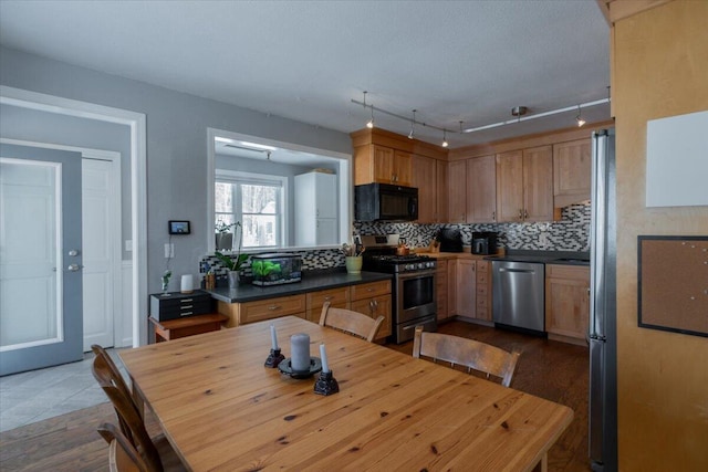 kitchen featuring stainless steel appliances and decorative backsplash