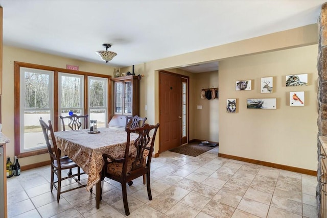 dining area featuring baseboards and a wealth of natural light