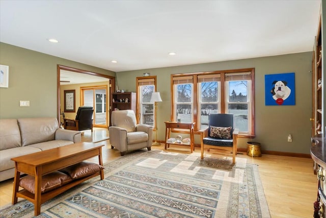 living room with recessed lighting, baseboards, and light wood finished floors