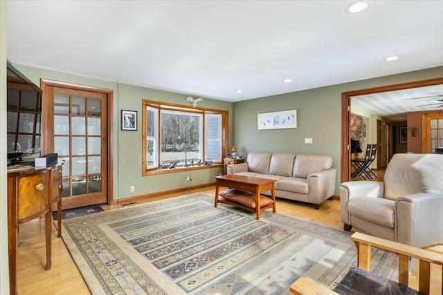 living room featuring recessed lighting, light wood-type flooring, and baseboards