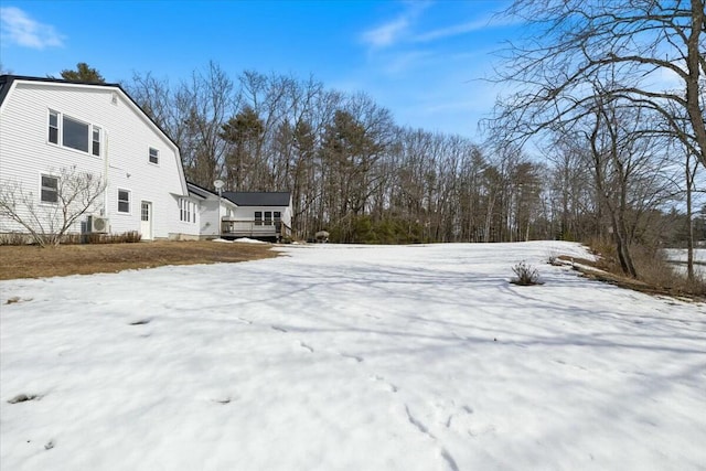 snow covered property with a wooden deck