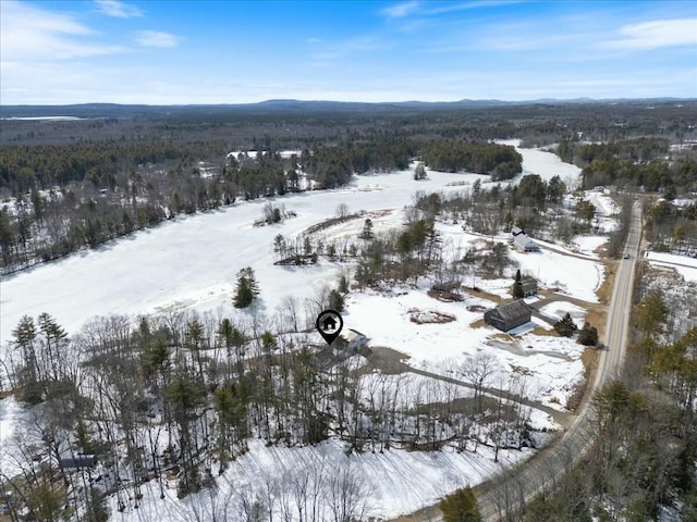 snowy aerial view with a mountain view