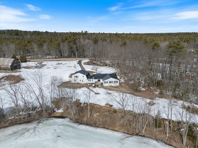 snowy aerial view with a forest view