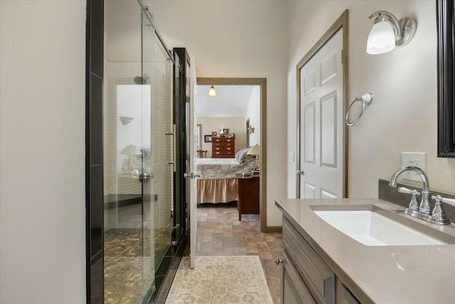 ensuite bathroom featuring connected bathroom, vanity, a shower stall, and stone finish floor