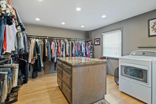 walk in closet featuring light wood-style flooring and washer / clothes dryer