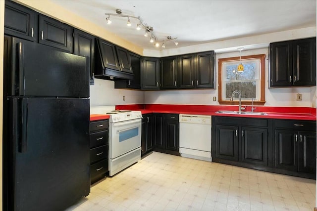 kitchen featuring dark cabinetry, white appliances, light floors, a sink, and custom range hood