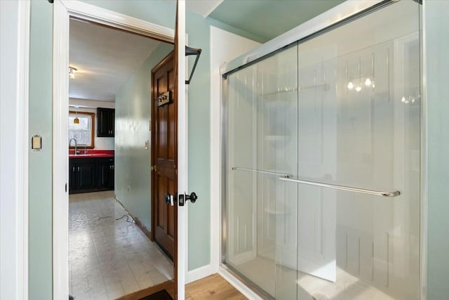 full bathroom featuring a shower stall and a sink