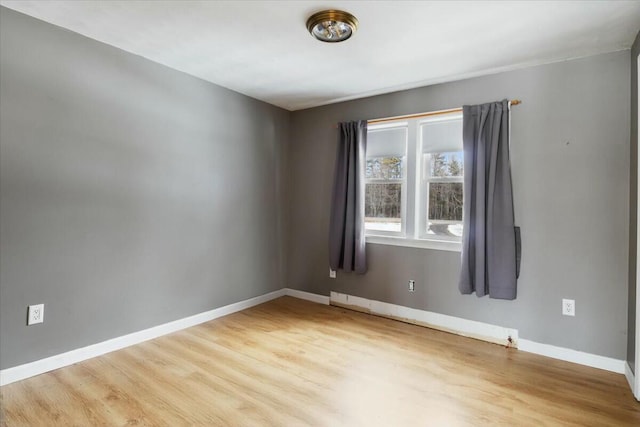 empty room with wood finished floors and baseboards