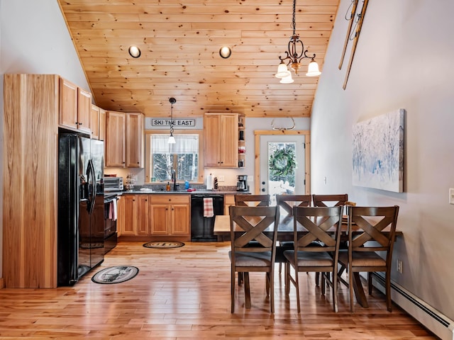 kitchen featuring sink, decorative light fixtures, a baseboard radiator, and black appliances