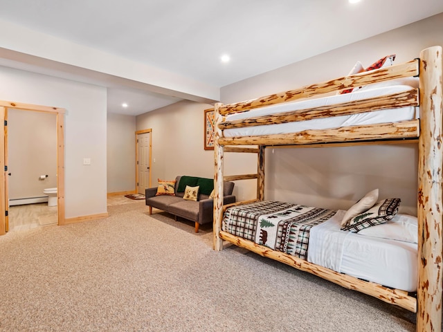 carpeted bedroom featuring baseboard heating and ensuite bathroom