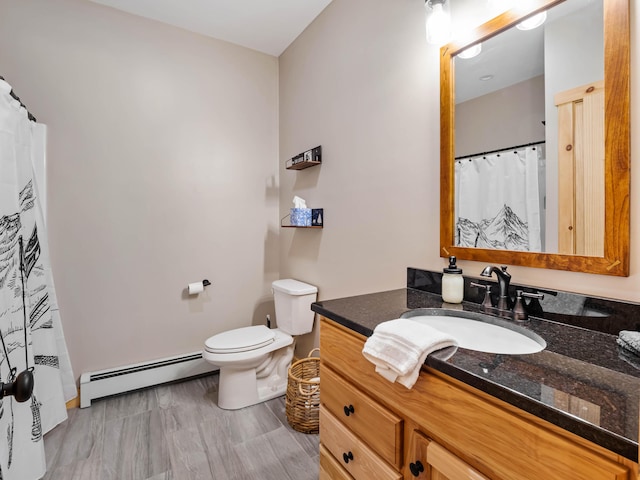 bathroom featuring a baseboard radiator, vanity, and toilet