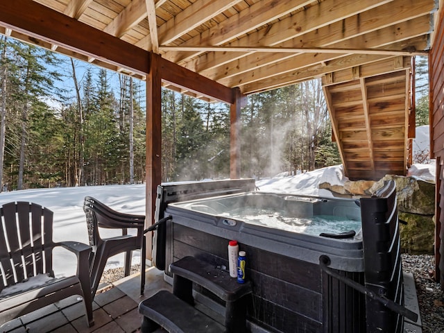 snow covered patio with a hot tub