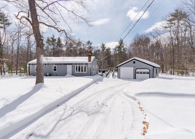 view of front facade featuring an outbuilding and a garage