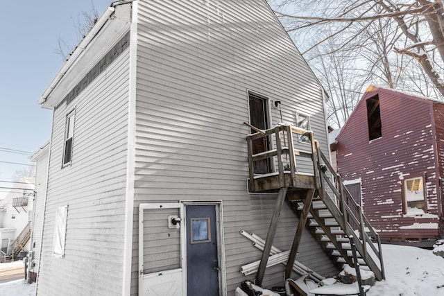 view of snow covered back of property