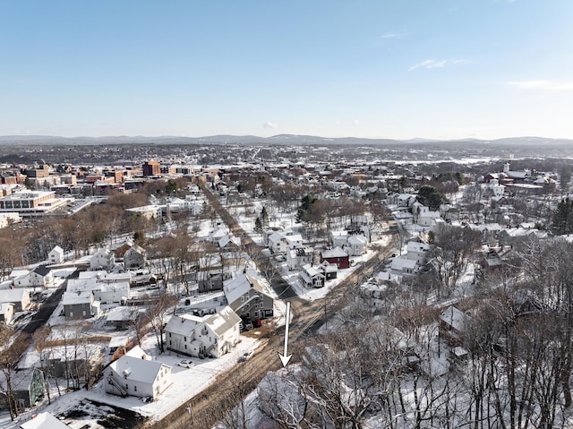 snowy aerial view with a mountain view