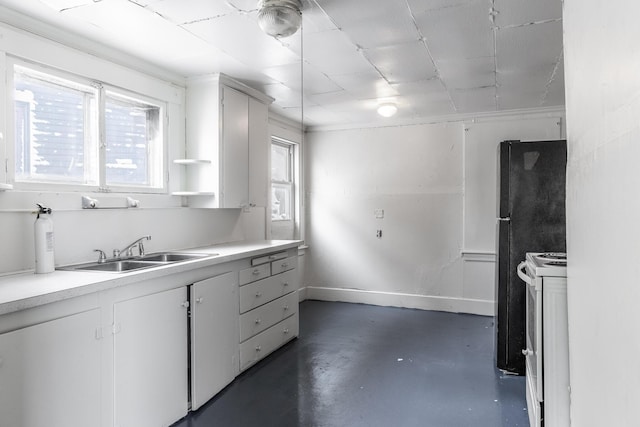 kitchen with white cabinetry, sink, white range, and black refrigerator