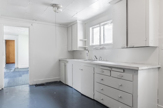 kitchen featuring white cabinetry and sink