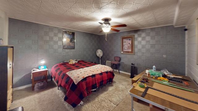 carpeted bedroom with an ornate ceiling, ceiling fan, baseboards, and ornamental molding