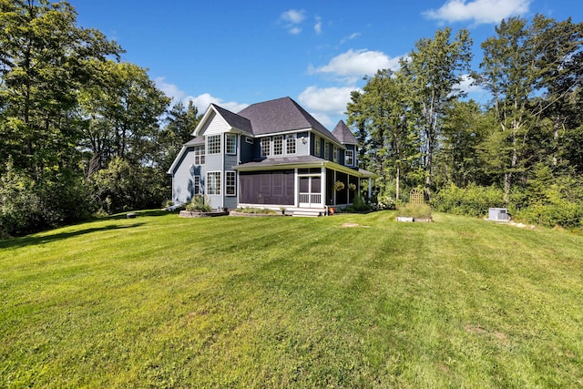 exterior space featuring a yard and a sunroom