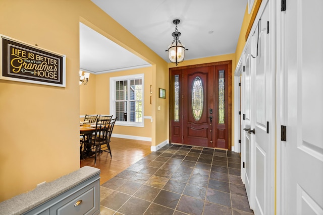 foyer entrance with an inviting chandelier