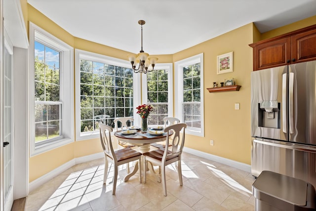 dining area with an inviting chandelier and light tile patterned flooring