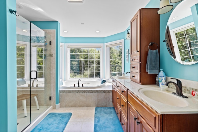 bathroom with tile patterned flooring, vanity, and independent shower and bath