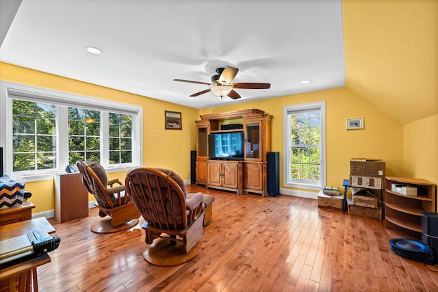 living room with ceiling fan and light hardwood / wood-style floors