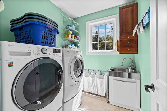 washroom featuring washer and dryer, sink, and light tile patterned floors