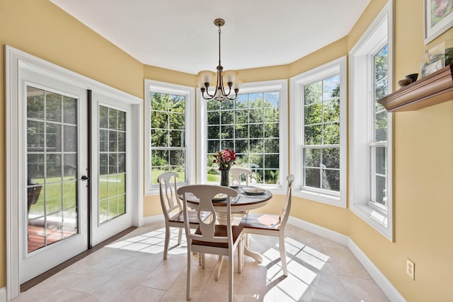 sunroom / solarium with a chandelier