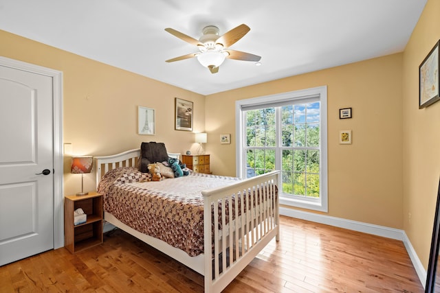 bedroom featuring wood-type flooring and ceiling fan