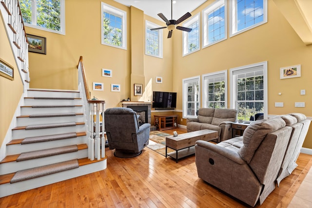 living room with ceiling fan and light hardwood / wood-style flooring