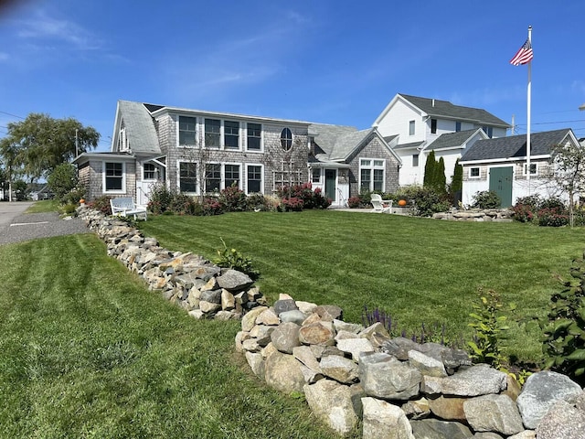 shingle-style home with a front yard