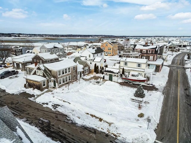 snowy aerial view with a residential view