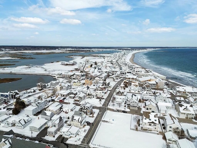 drone / aerial view with a beach view, a residential view, and a water view